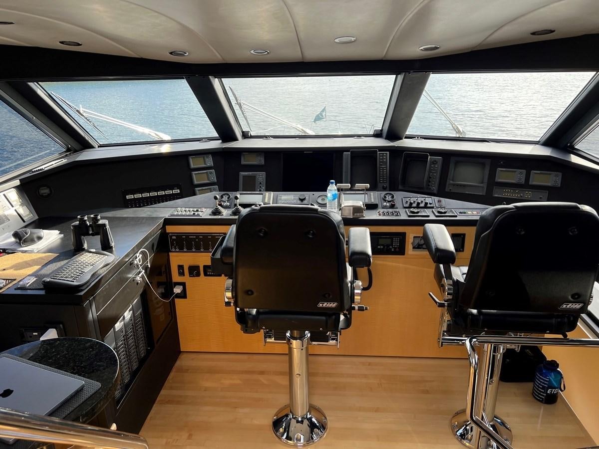 a large black and white piano in a room with a large window aboard OREGON MIST Yacht for Sale