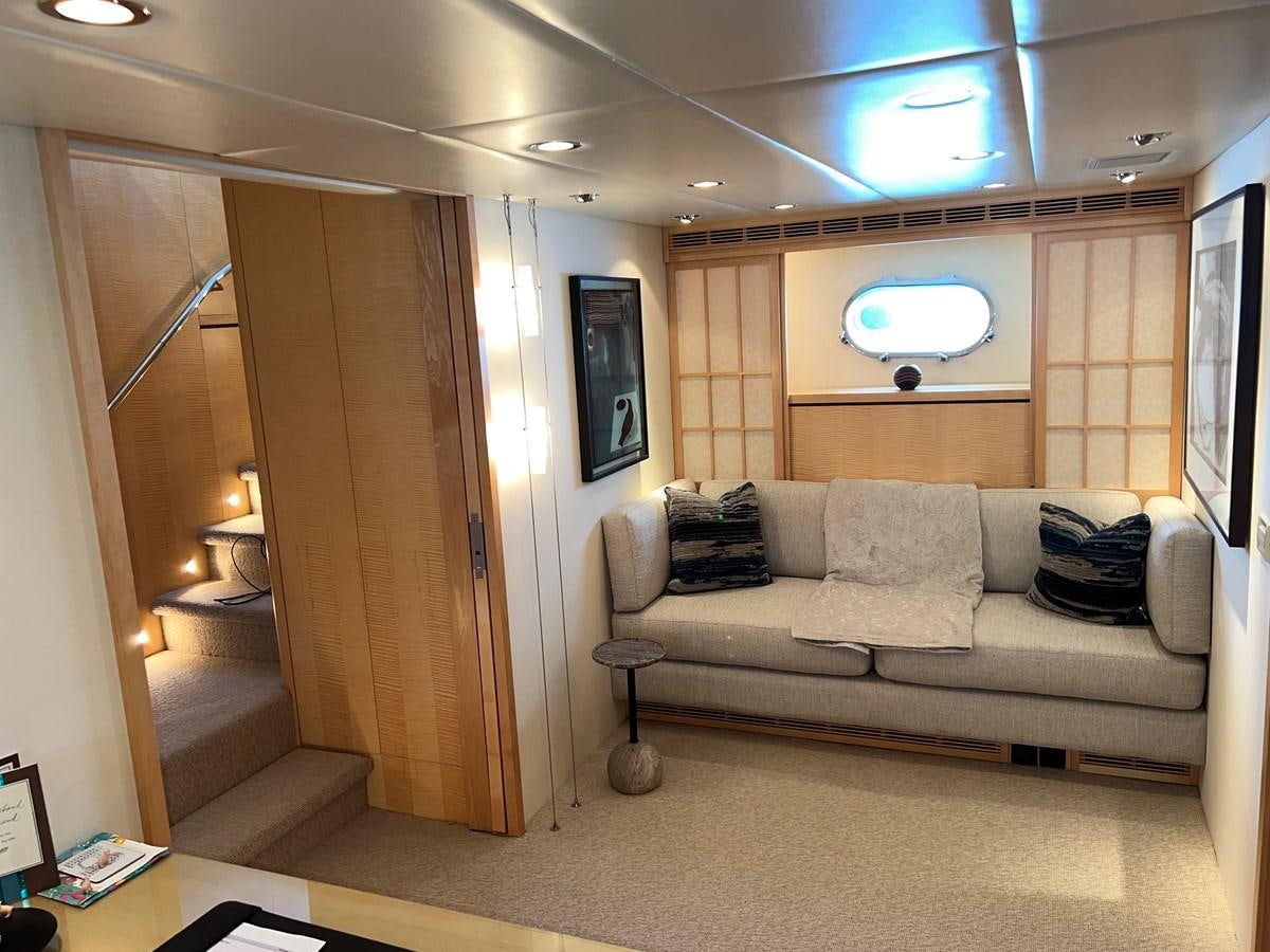 a living room with a couch and a television aboard OREGON MIST Yacht for Sale