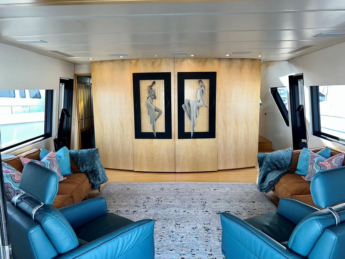 a living room with a large screen aboard OREGON MIST Yacht for Sale