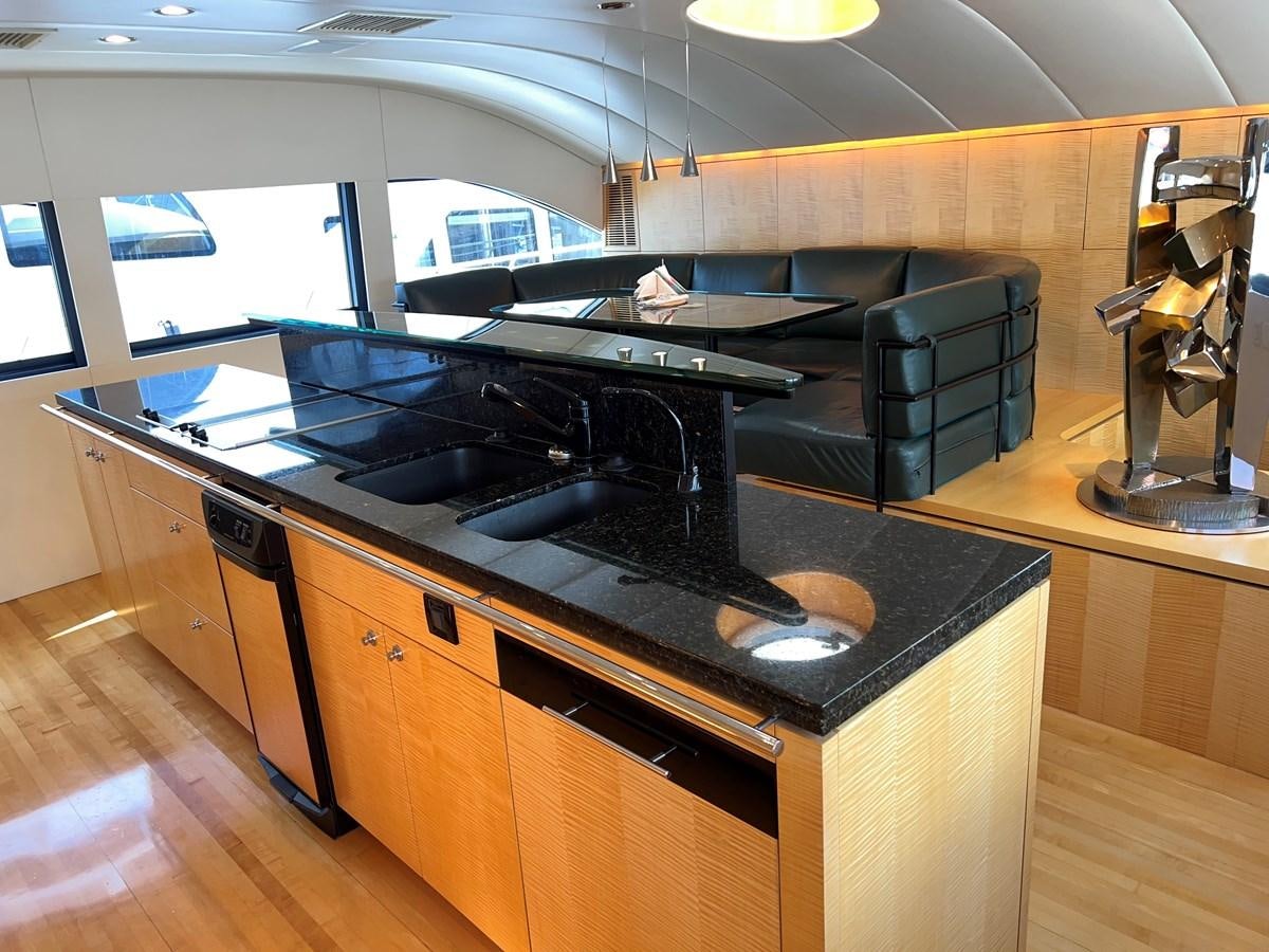a kitchen with a stove and a large window aboard OREGON MIST Yacht for Sale