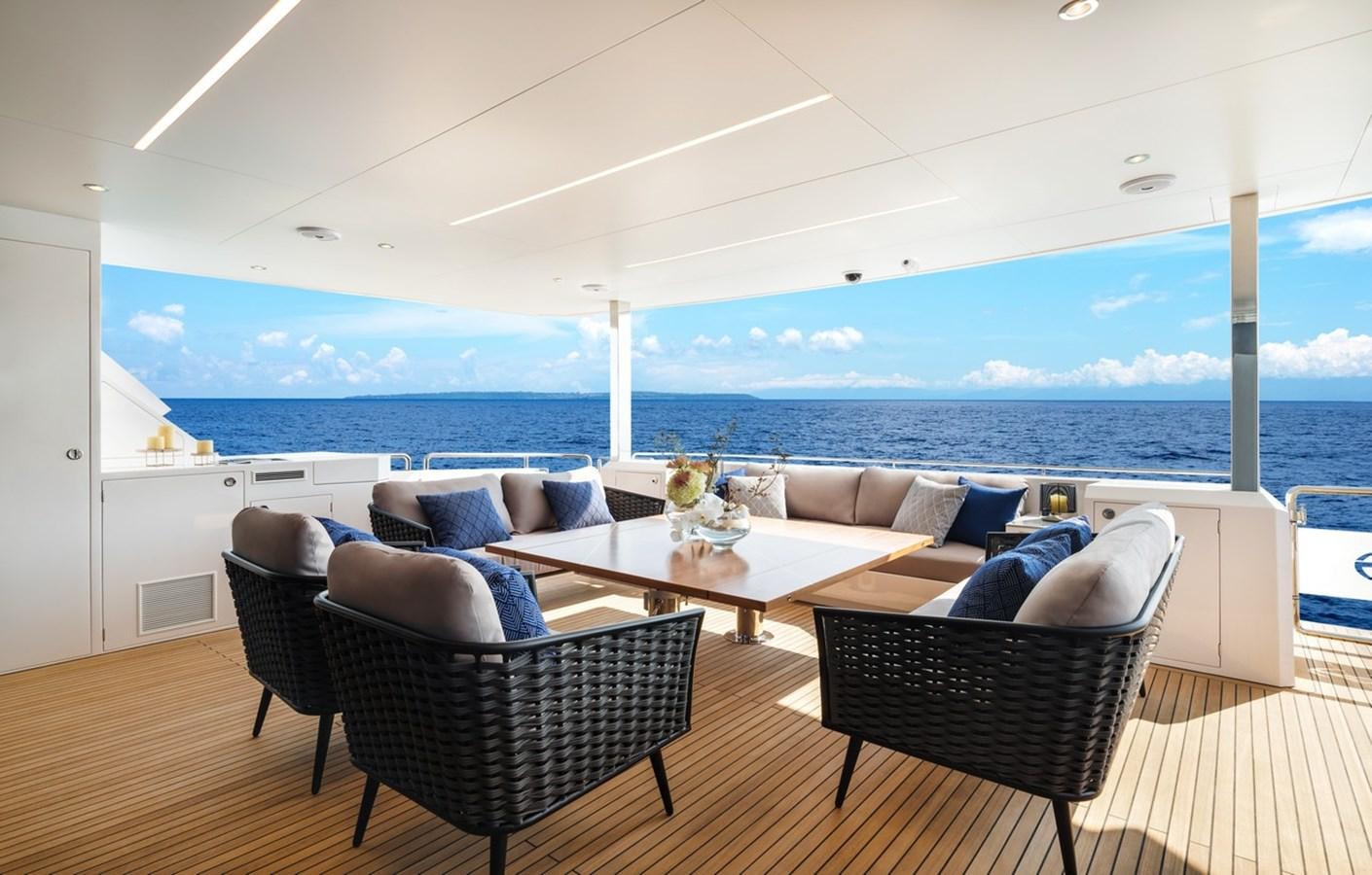a patio with a table and chairs aboard HORIZON FD90/30 Yacht for Sale