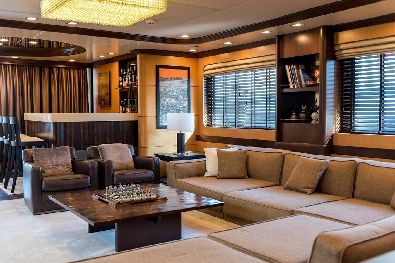 a living room with a couch and a coffee table aboard SERENITY II Yacht for Sale