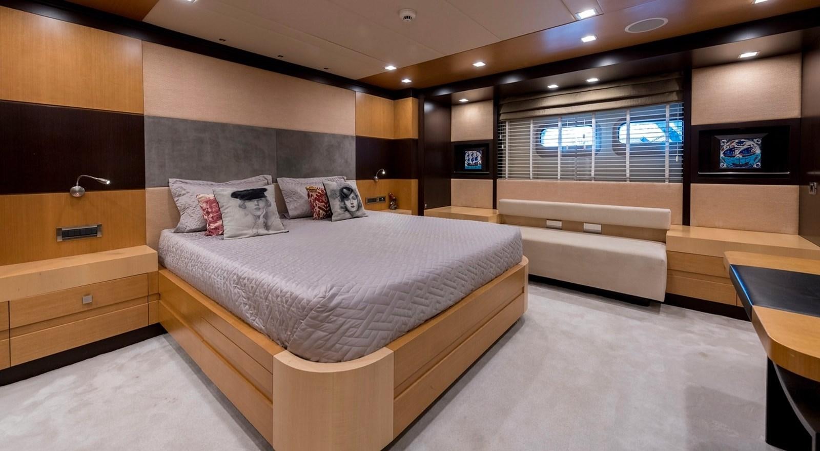 a room with a bed and a tv aboard SERENITY II Yacht for Sale