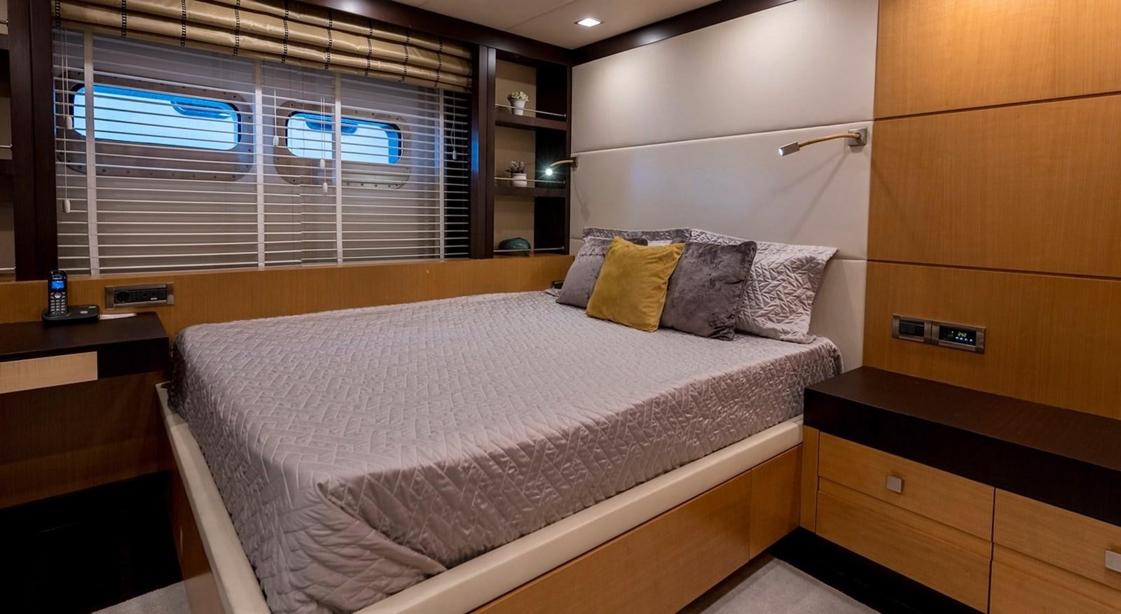 a bed with a white comforter aboard SERENITY II Yacht for Sale