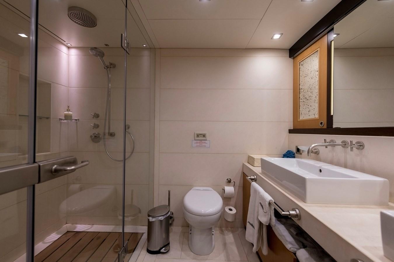 a bathroom with a glass shower aboard SERENITY II Yacht for Sale