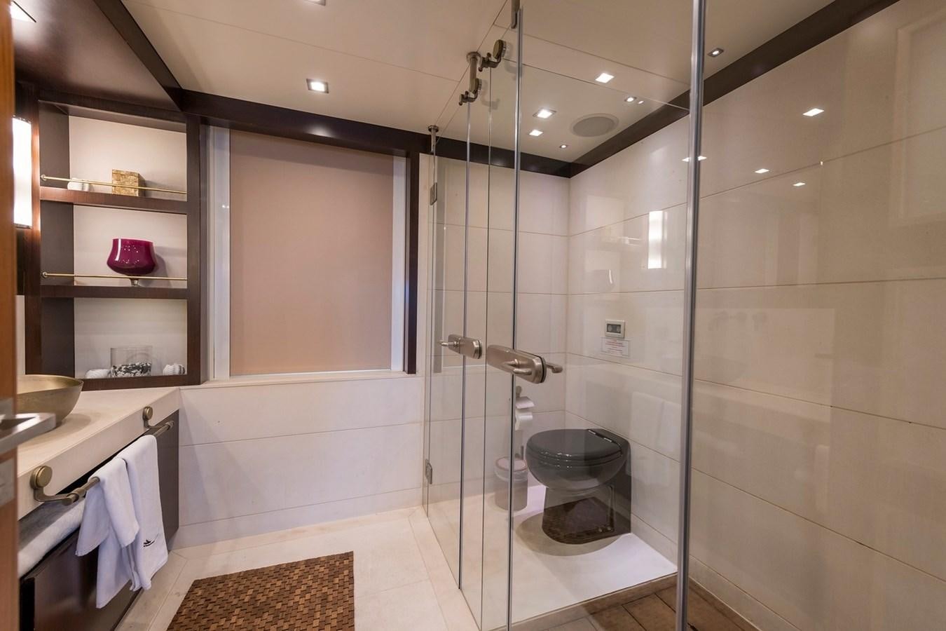 a bathroom with a glass shower aboard SERENITY II Yacht for Sale