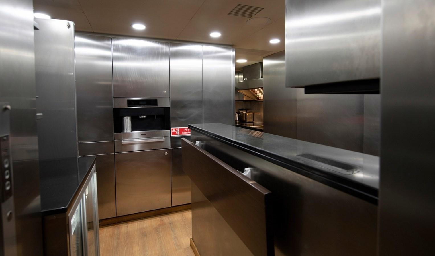 a kitchen with stainless steel appliances aboard SERENITY II Yacht for Sale