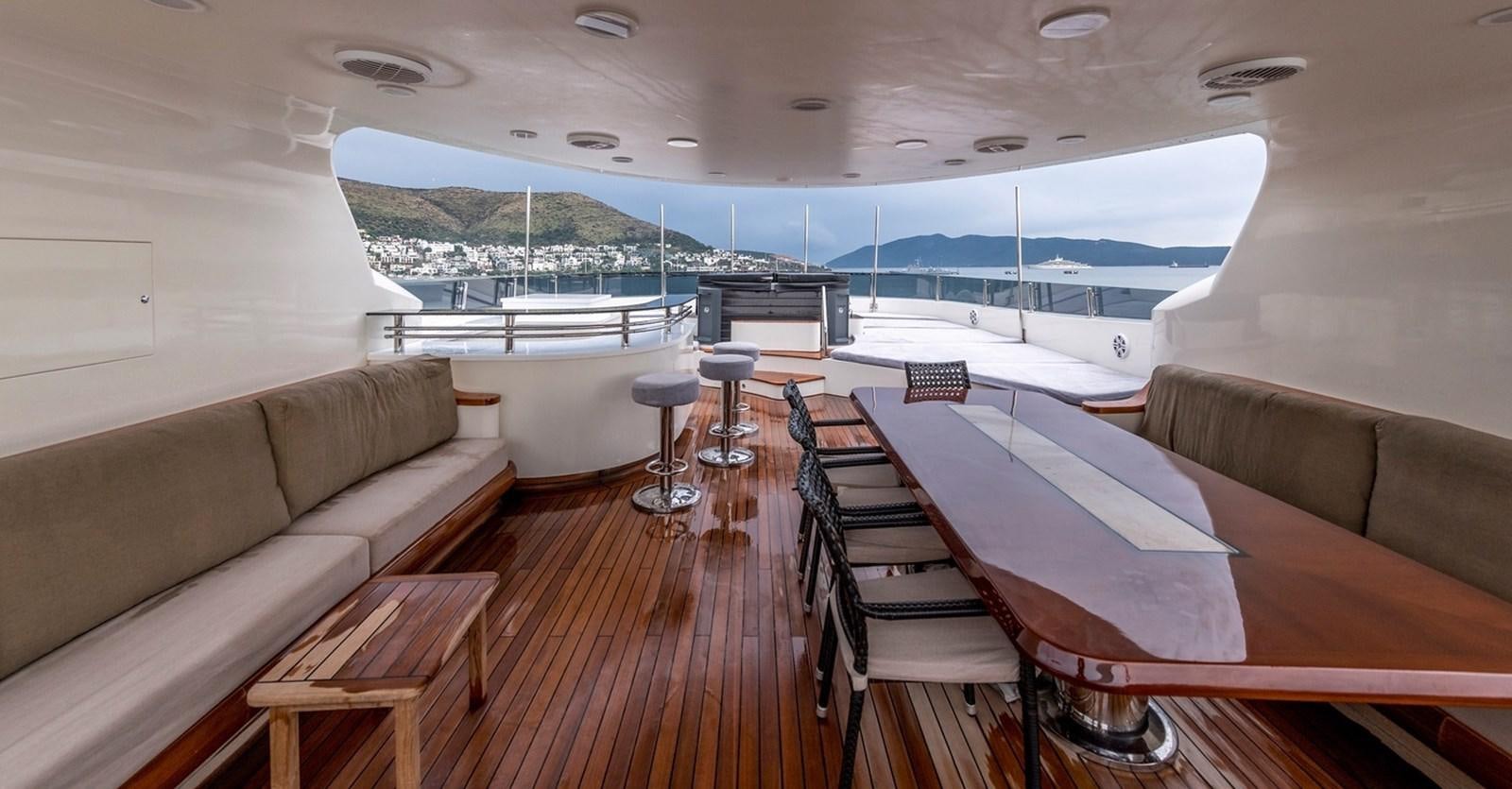 a living room with a couch and a table aboard SERENITY II Yacht for Sale