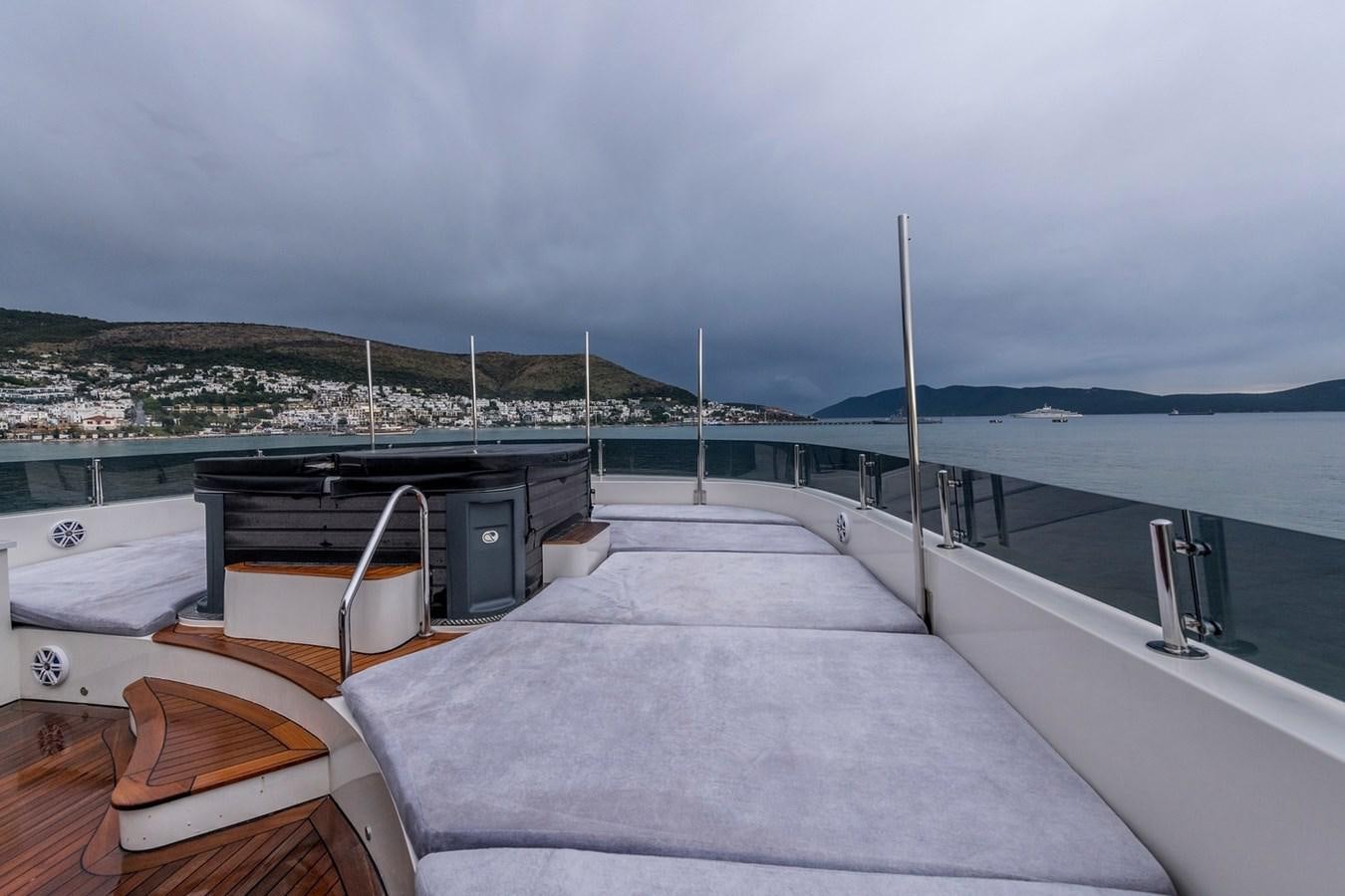a deck with a view of a city and water aboard SERENITY II Yacht for Sale