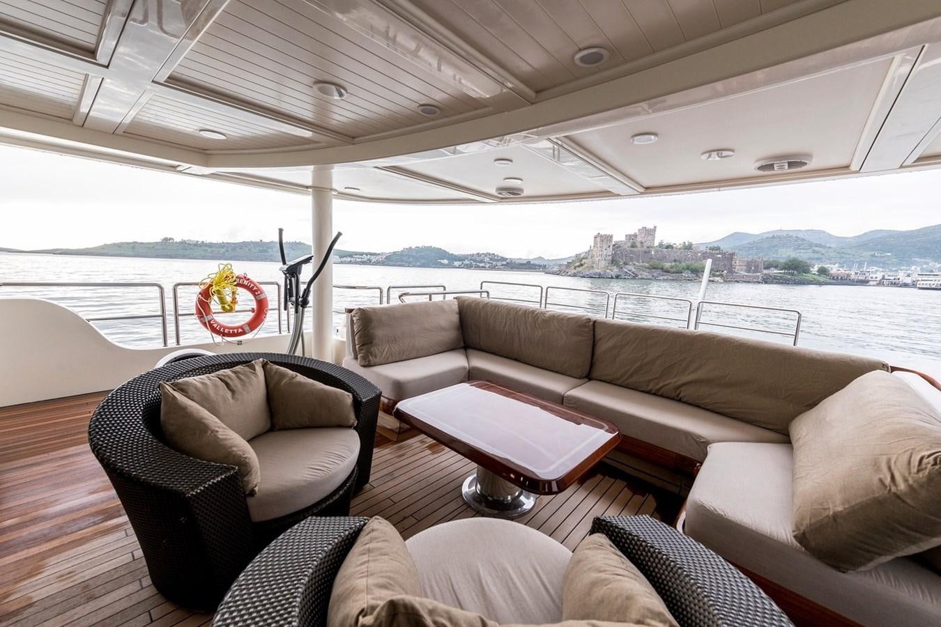 a boat with a couch and a chair in it aboard SERENITY II Yacht for Sale