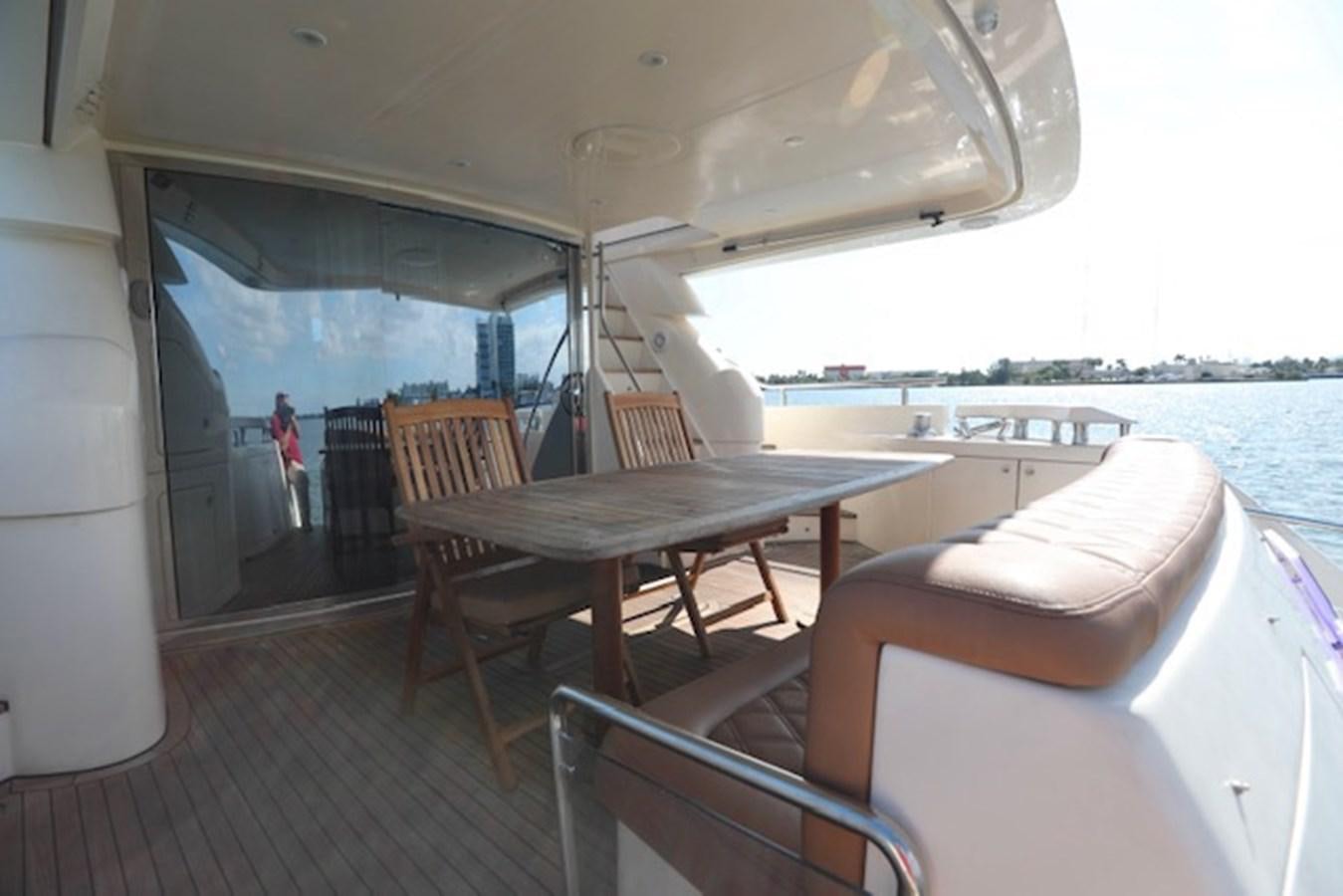 a boat with a table and chairs on a deck aboard K3 Yacht for Sale