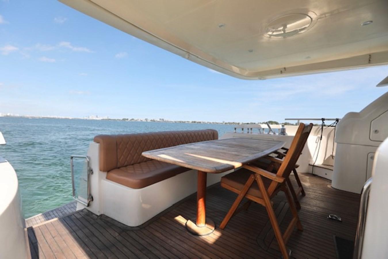 a table and chairs on a boat aboard K3 Yacht for Sale