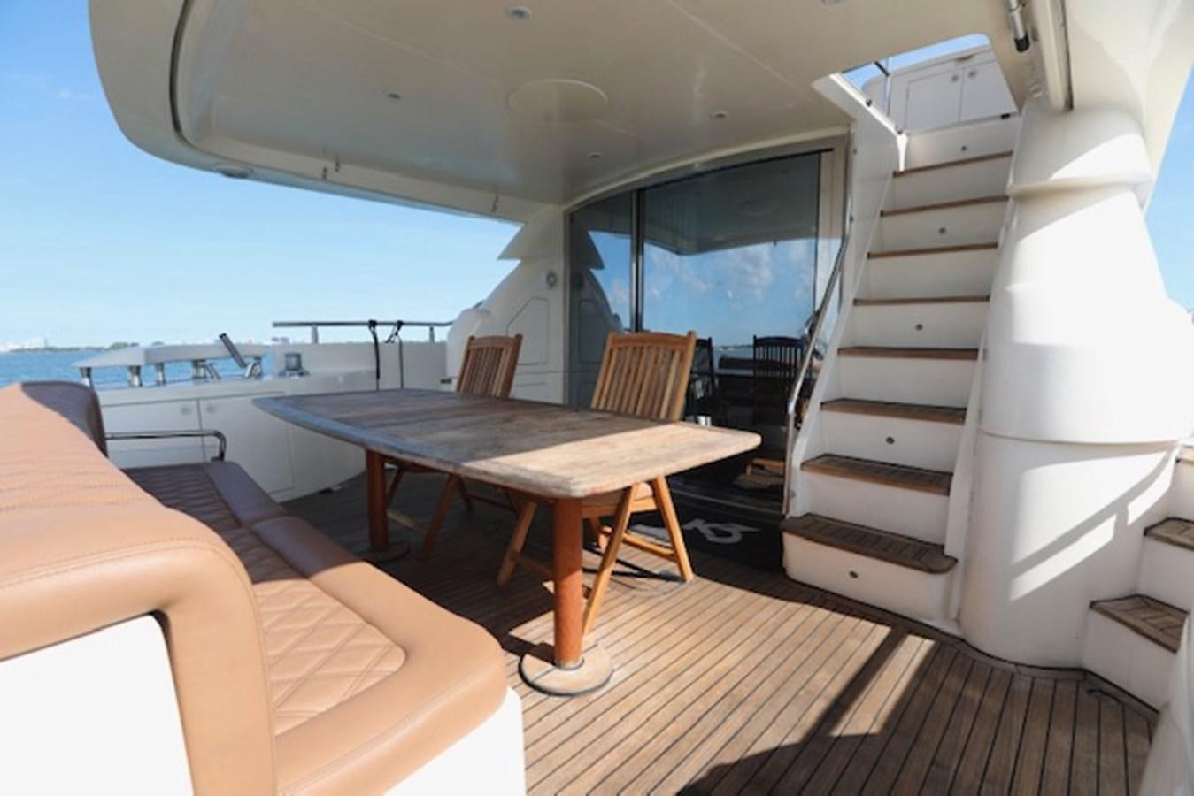 a room with a table and chairs aboard K3 Yacht for Sale