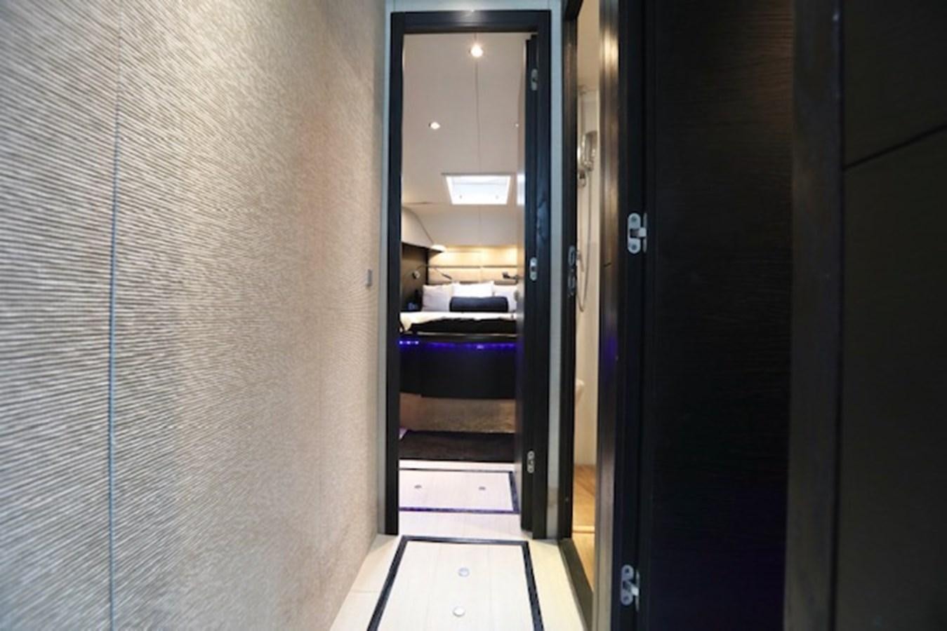 a hallway with a door and a bed aboard K3 Yacht for Sale
