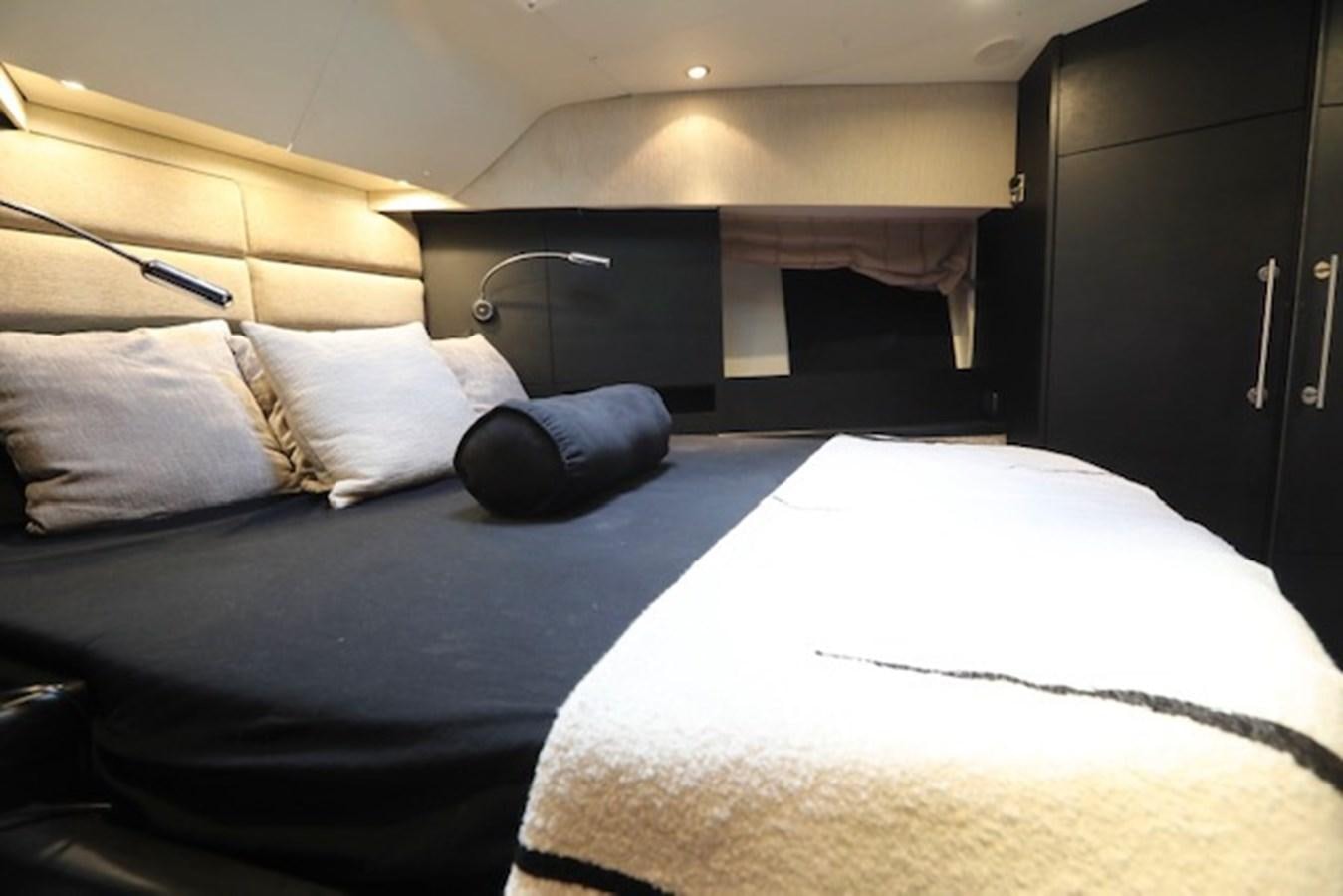 a bed with white sheets aboard K3 Yacht for Sale