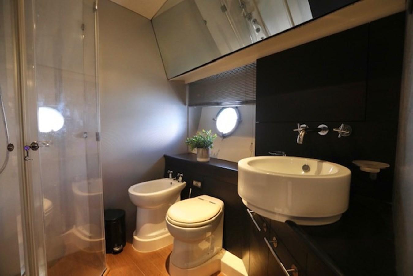 a bathroom with a sink toilet and a bathtub aboard K3 Yacht for Sale
