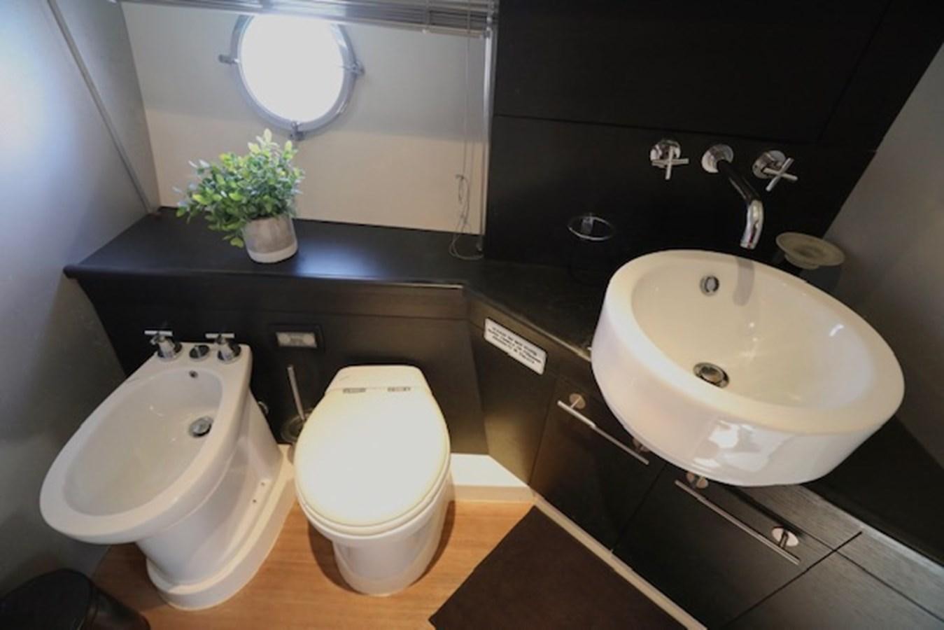a bathroom with a sink and a toilet aboard K3 Yacht for Sale
