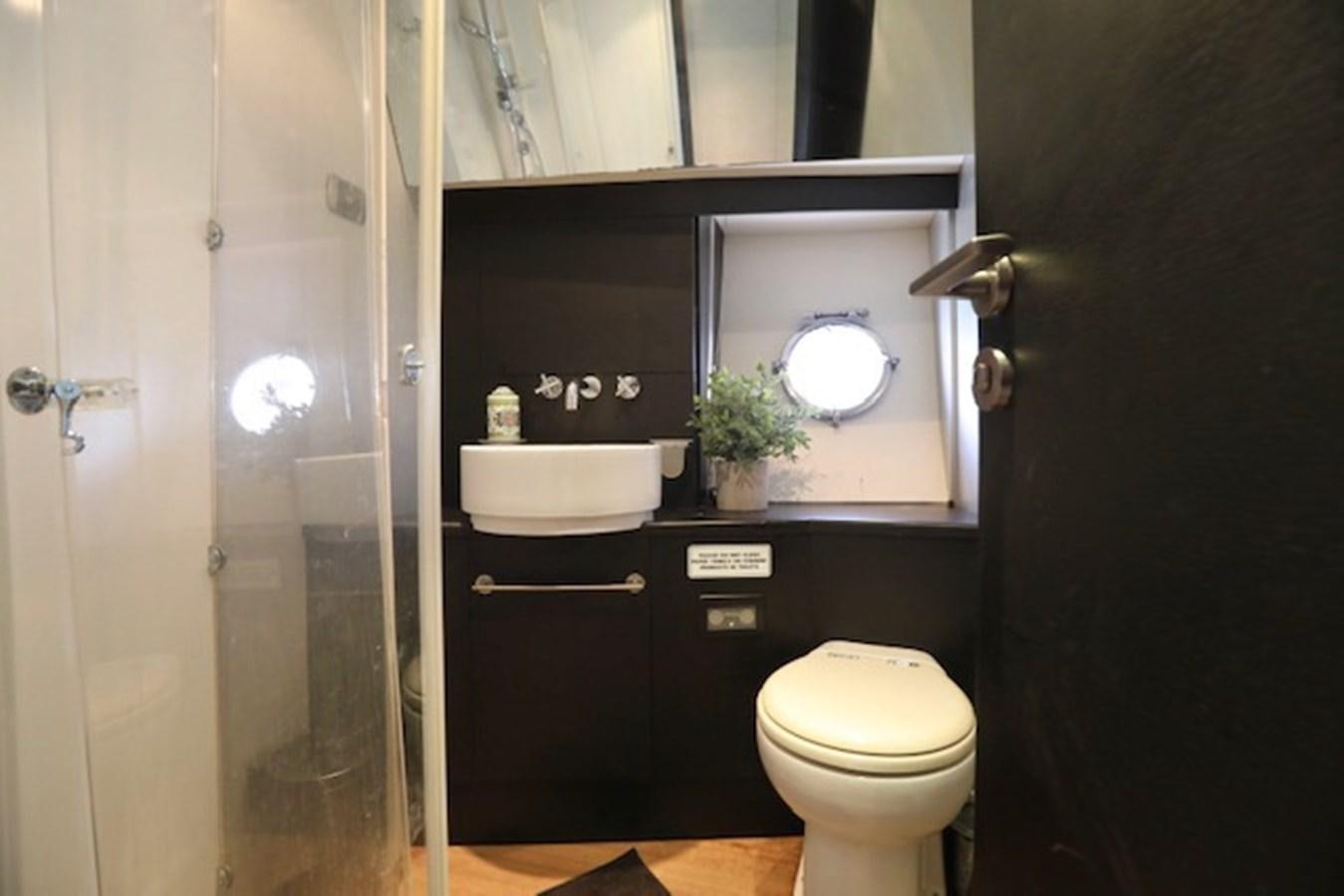 a bathroom with a toilet and a sink aboard K3 Yacht for Sale
