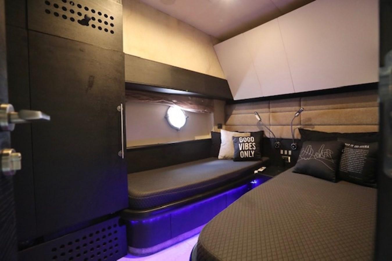 a room with a bed and a television aboard K3 Yacht for Sale