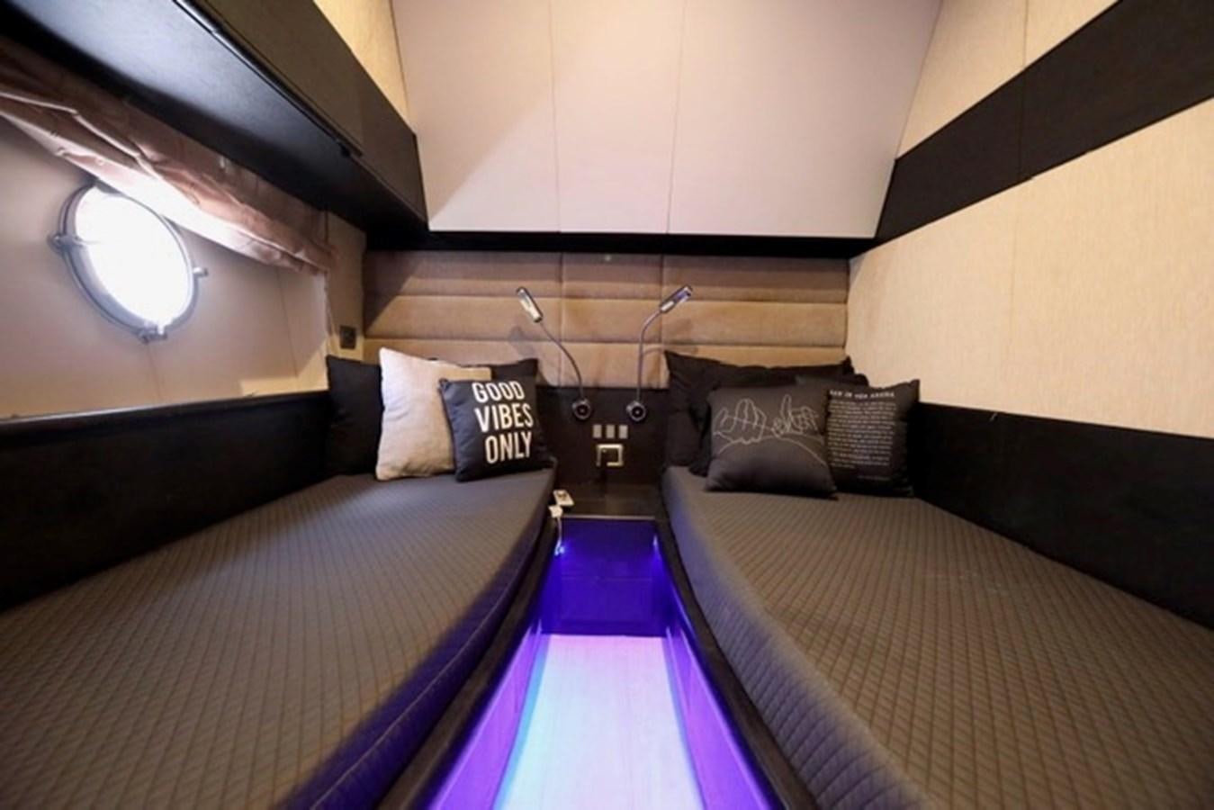 a room with a bed and a window aboard K3 Yacht for Sale