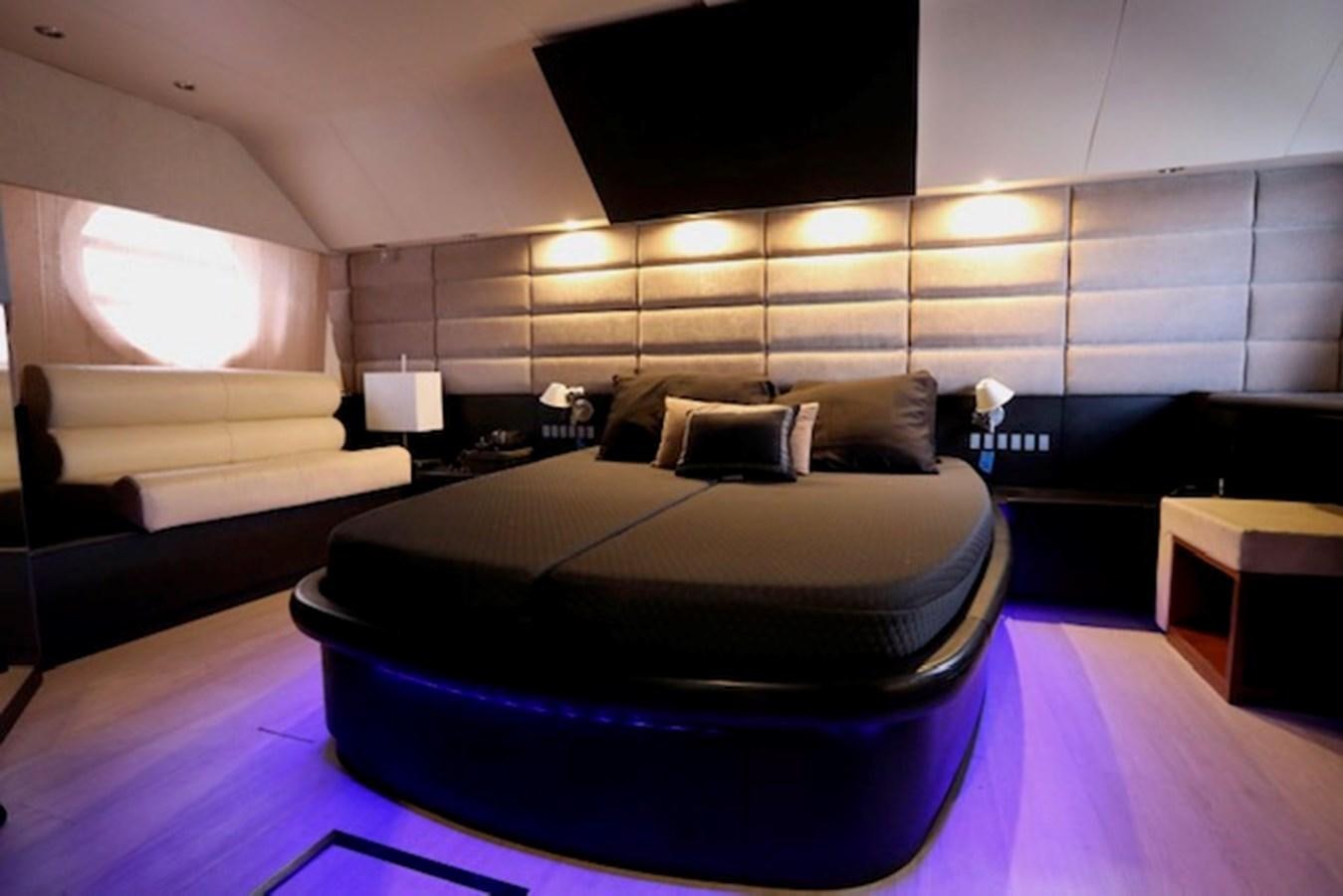 a room with a bed and a purple rug aboard K3 Yacht for Sale
