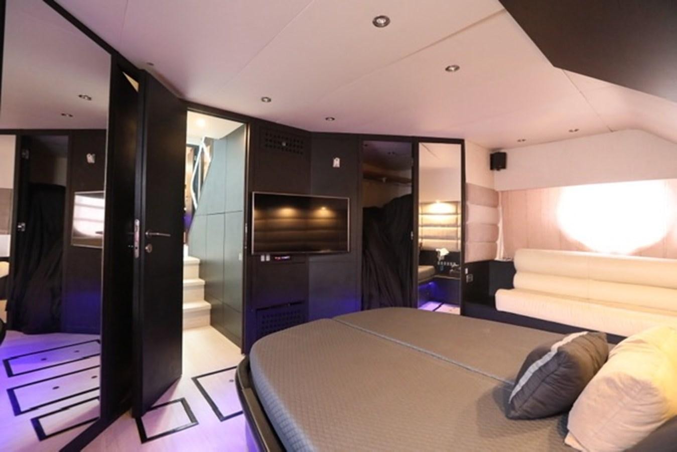 a room with a bed and a television aboard K3 Yacht for Sale
