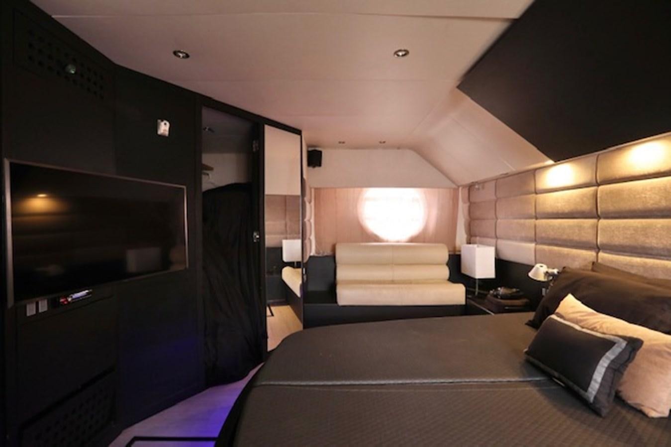 a bedroom with a bed and a tv aboard K3 Yacht for Sale