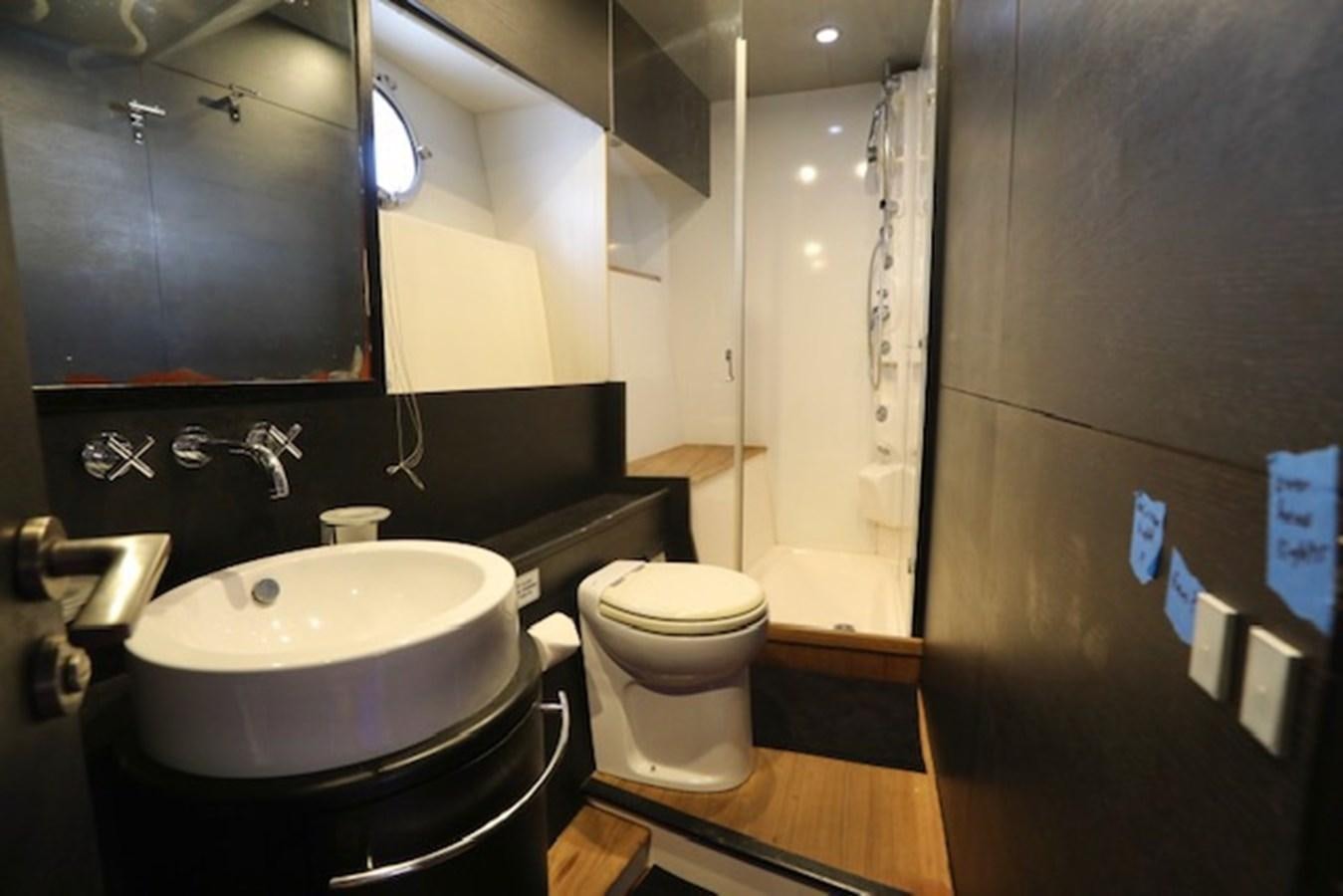 a bathroom with a sink toilet and a bathtub aboard K3 Yacht for Sale
