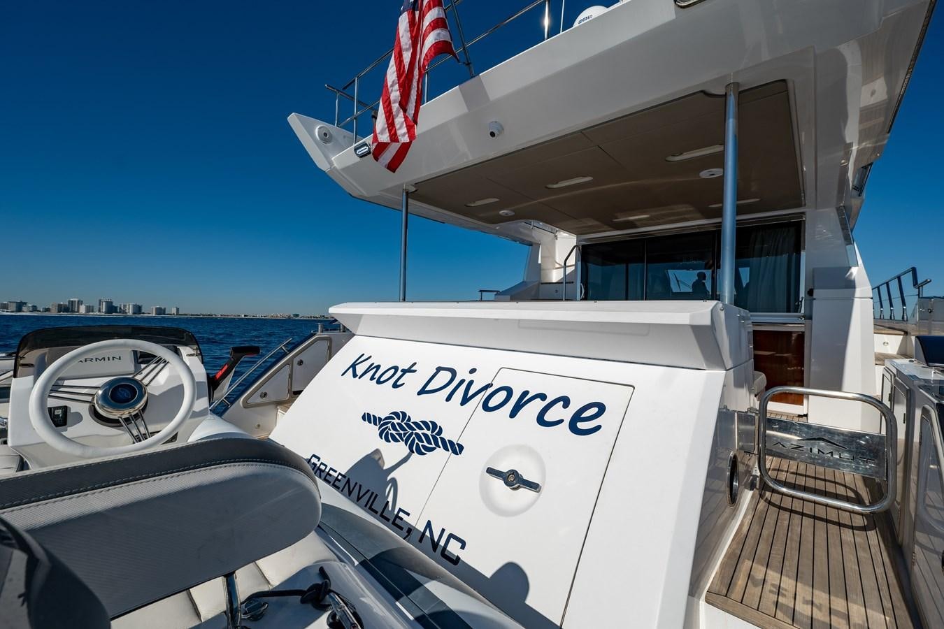 a boat with a flag on the front aboard KNOT DIVORCE Yacht for Sale