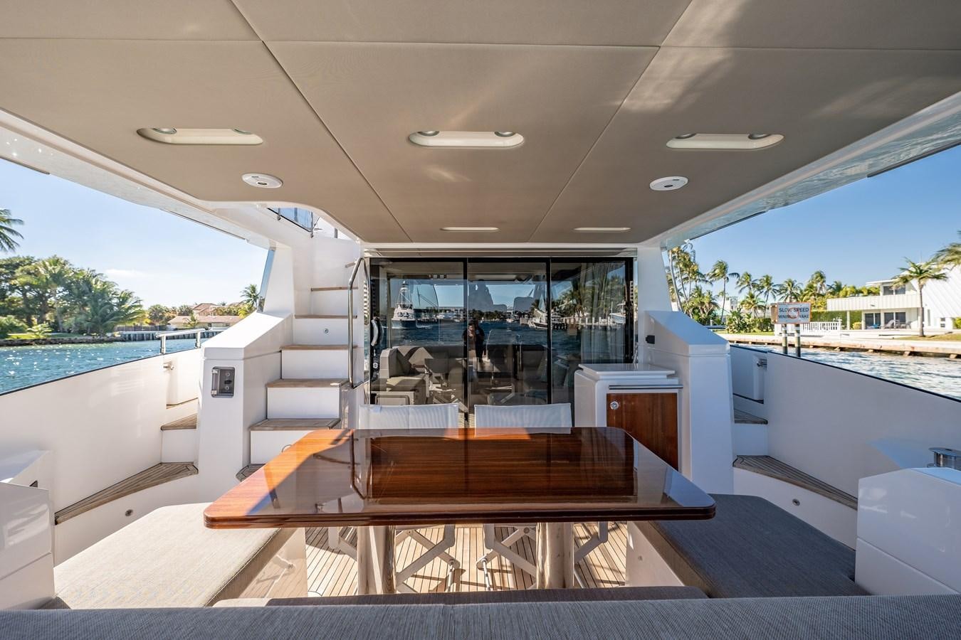 a large open area with a table and chairs and a pool aboard KNOT DIVORCE Yacht for Sale
