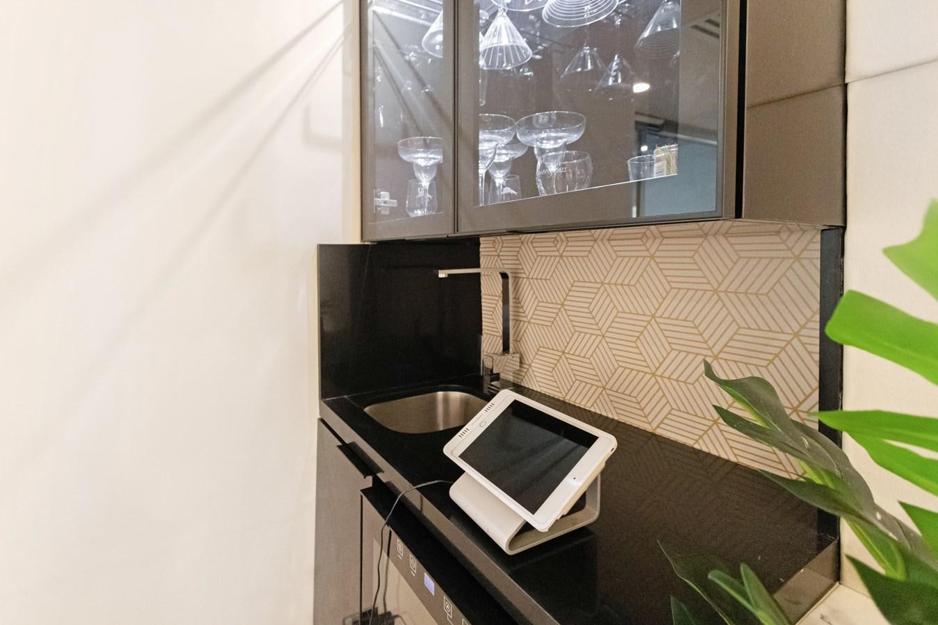 a laptop on a counter aboard MAC Yacht for Sale