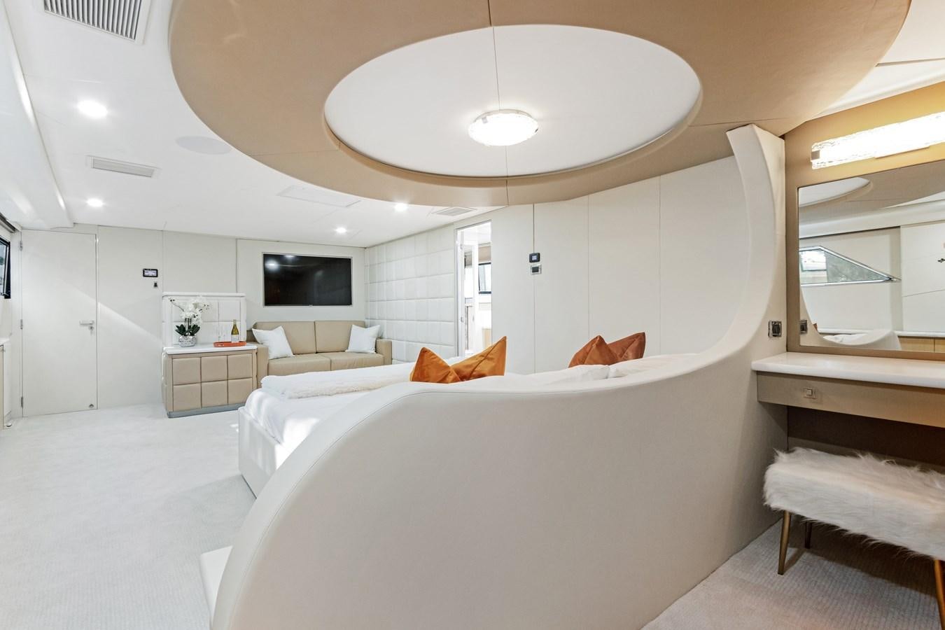 a white bedroom with a large white bed and a white wall aboard MAC Yacht for Sale