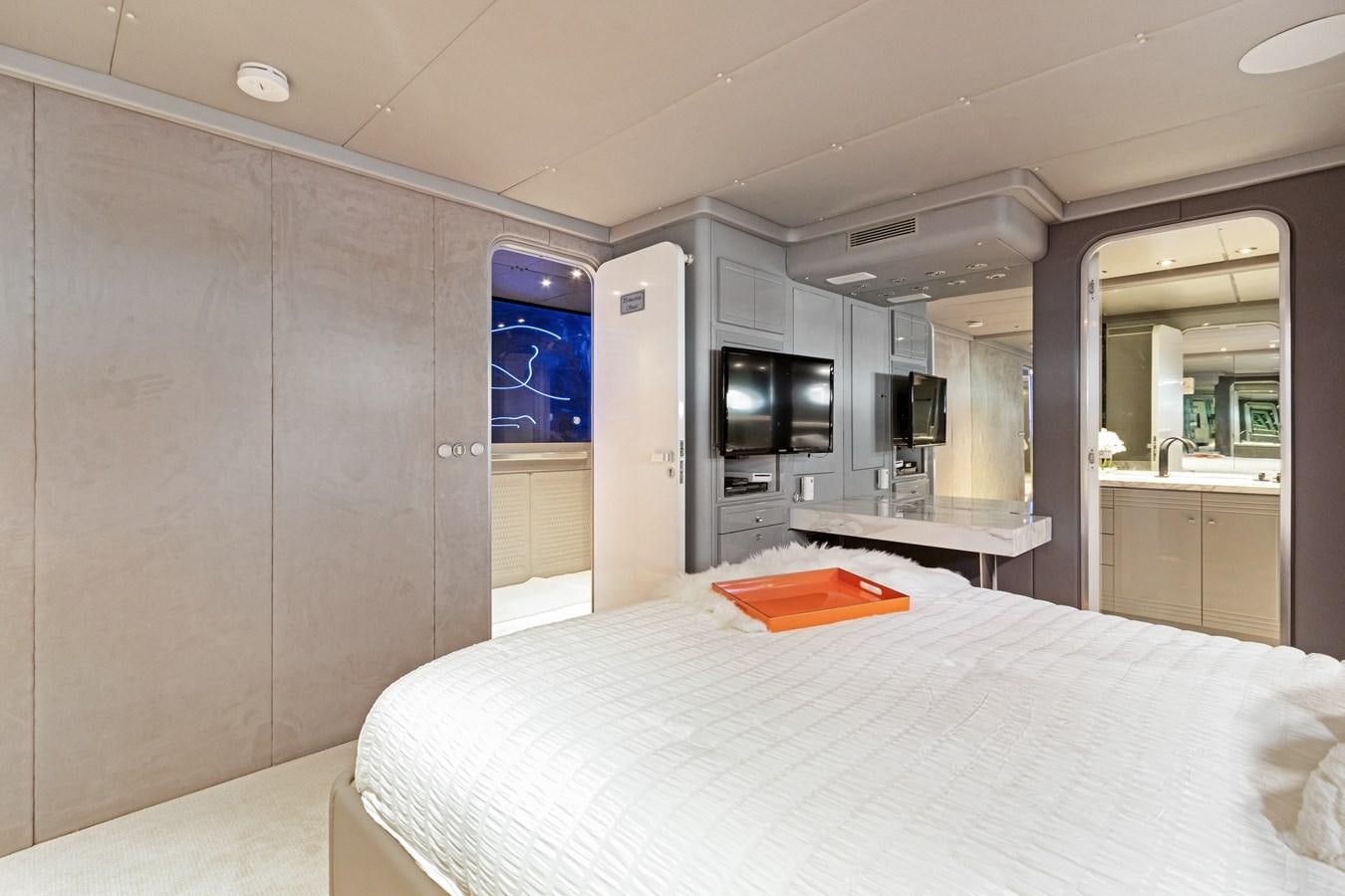 a large room with a bed and a desk aboard MAC Yacht for Sale