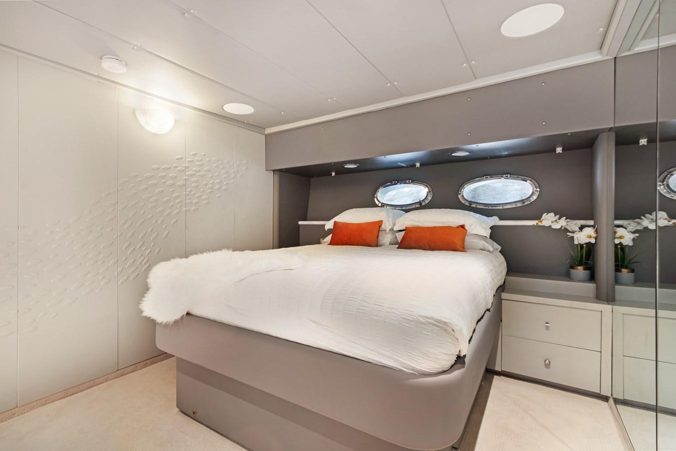 a white bed in a room aboard MAC Yacht for Sale