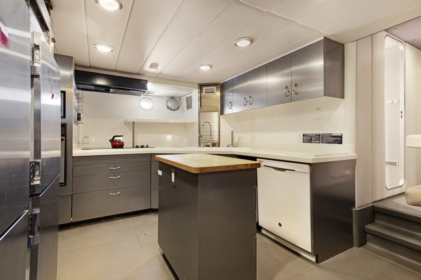 a kitchen with stainless steel appliances aboard MAC Yacht for Sale
