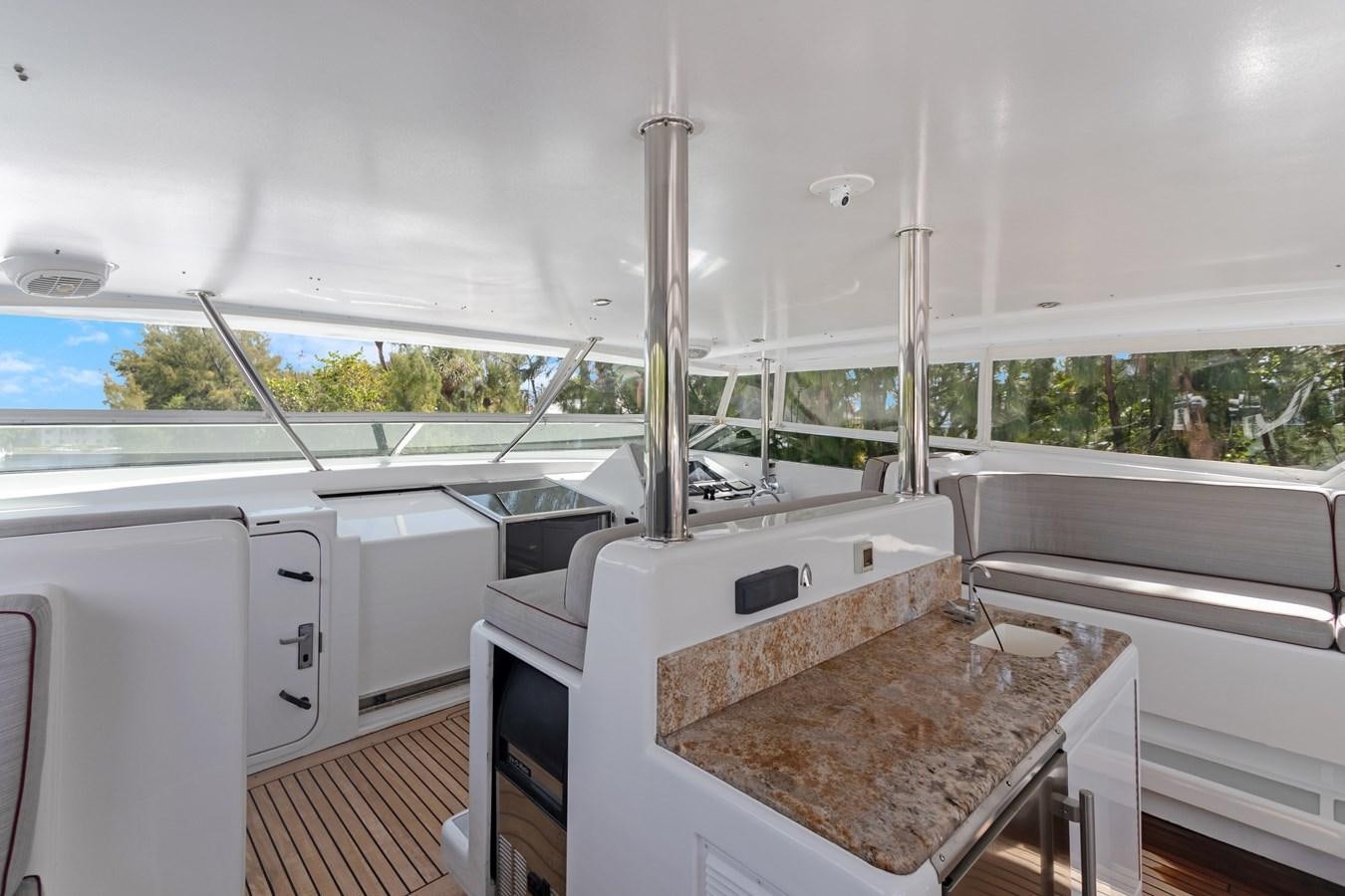 a large white kitchen with a large window aboard MAC Yacht for Sale