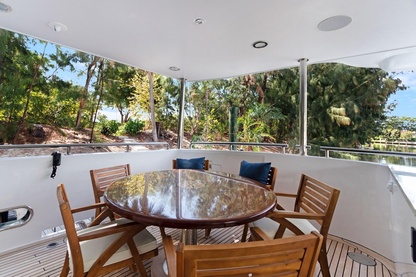 a table and chairs on a deck aboard MAC Yacht for Sale
