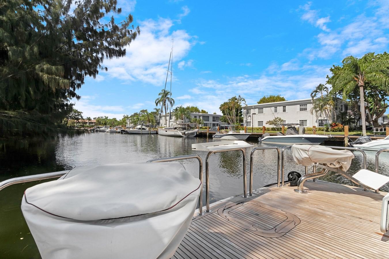 a body of water with boats and trees on the side aboard MAC Yacht for Sale