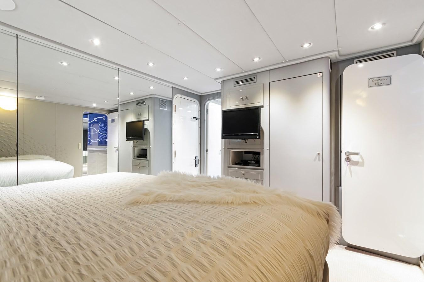 a bedroom with a bed and a television aboard MAC Yacht for Sale
