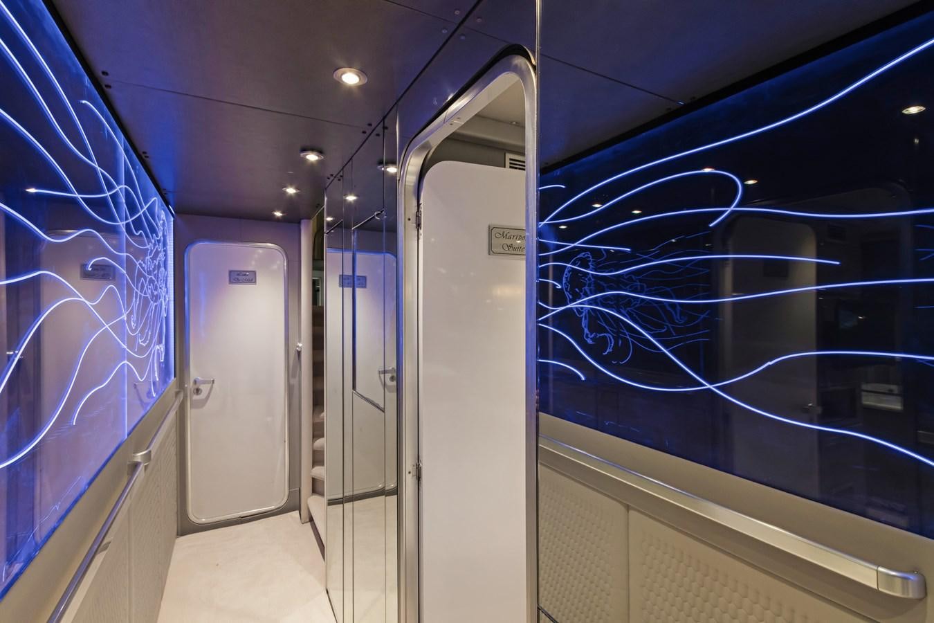 a hallway with glass doors aboard MAC Yacht for Sale