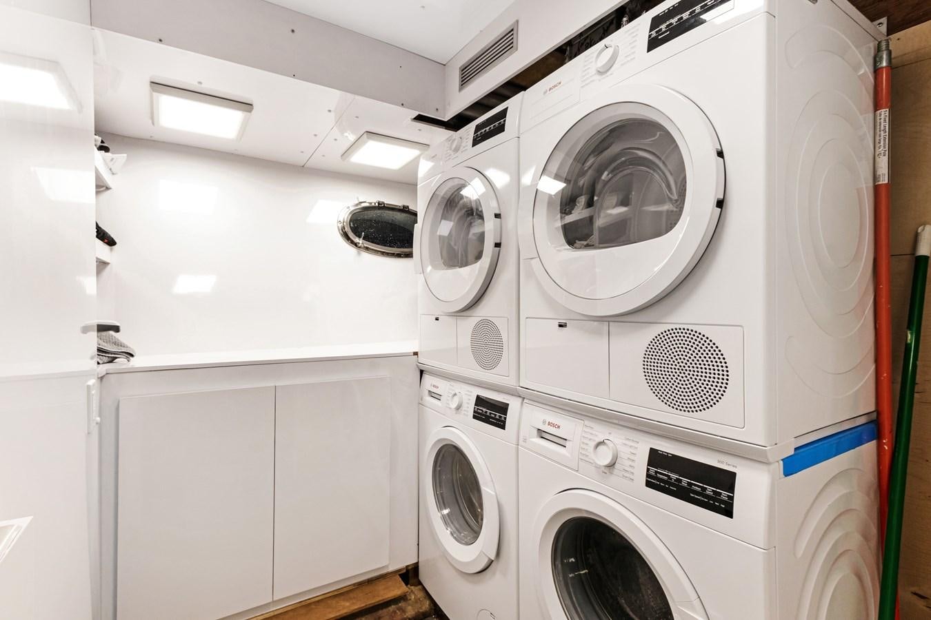 a row of washing machines aboard MAC Yacht for Sale