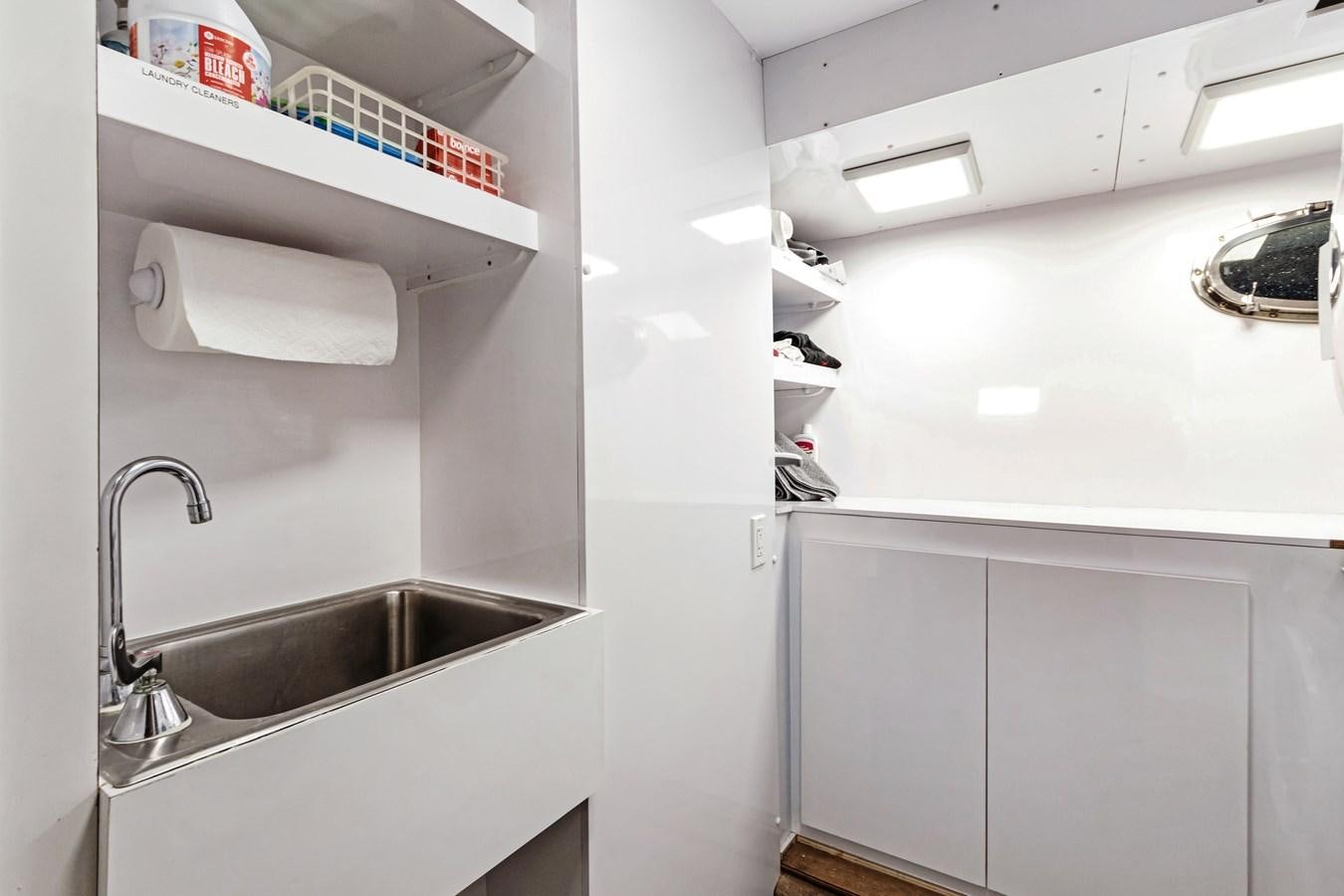 a kitchen with a sink and shelves aboard MAC Yacht for Sale