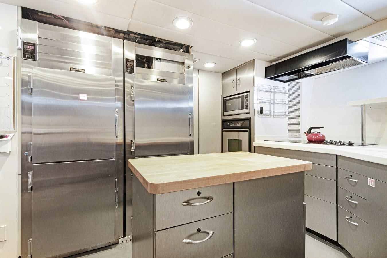 a kitchen with stainless steel appliances aboard MAC Yacht for Sale