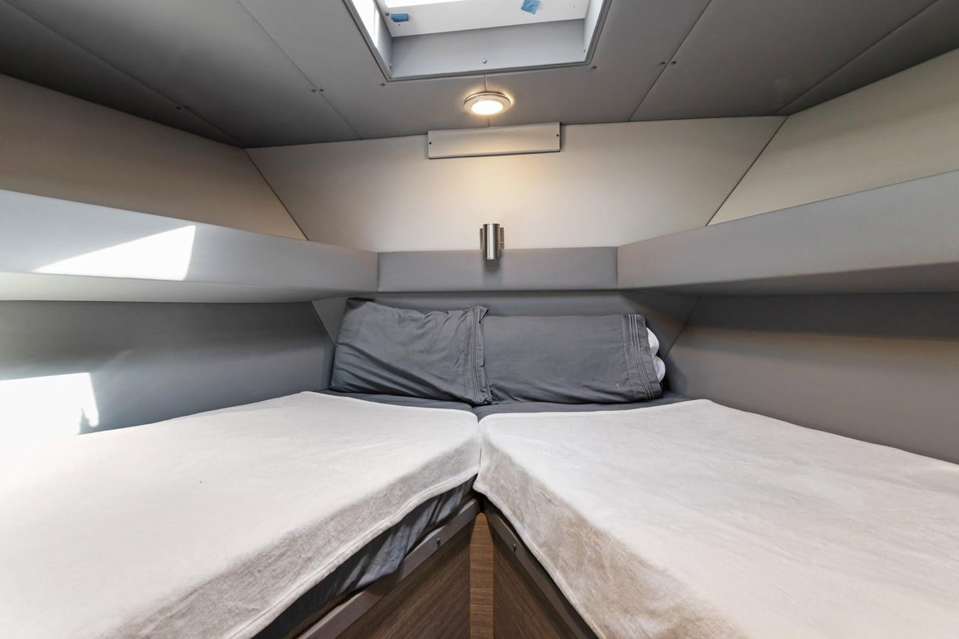 a couple of beds in a room aboard MAC Yacht for Sale