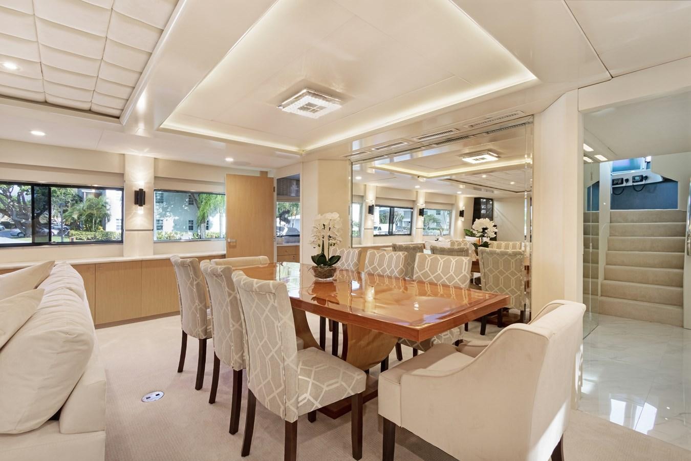 a large dining table in a room aboard MAC Yacht for Sale