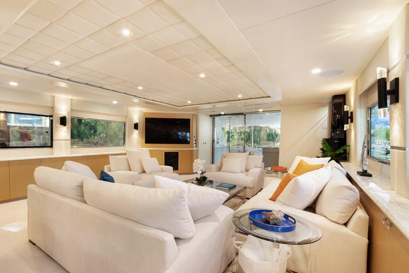 a living room with white couches aboard MAC Yacht for Sale