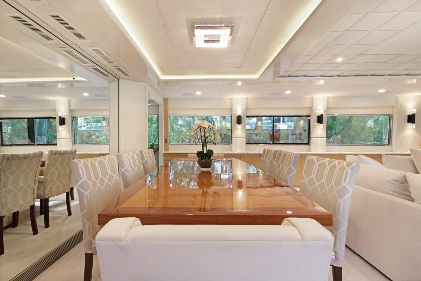 a room with a table and chairs aboard MAC Yacht for Sale