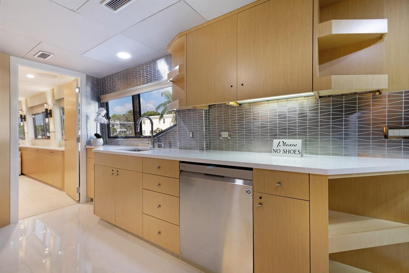 a kitchen with a tile wall aboard MAC Yacht for Sale