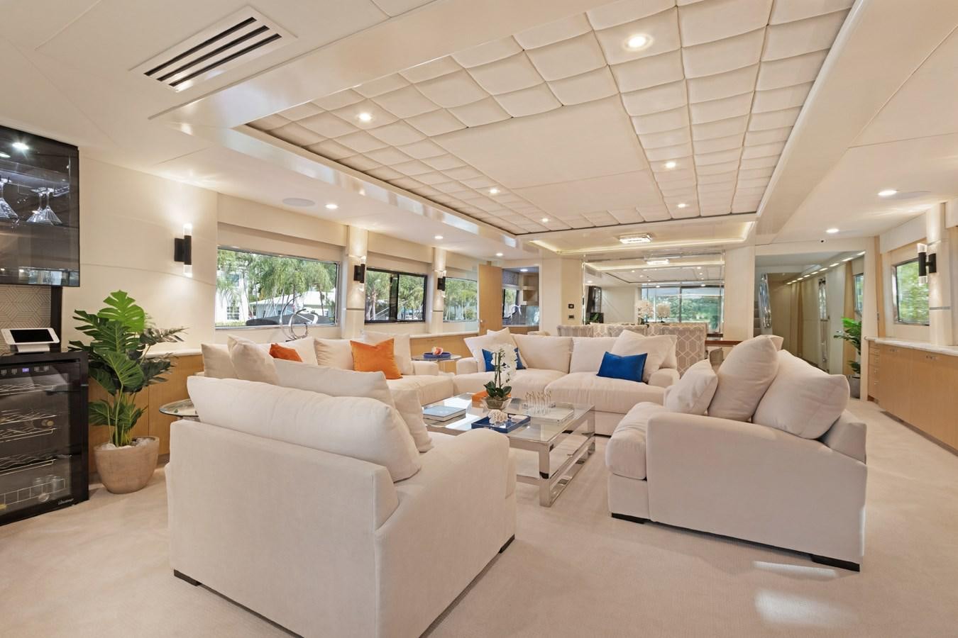 a living room with white couches aboard MAC Yacht for Sale