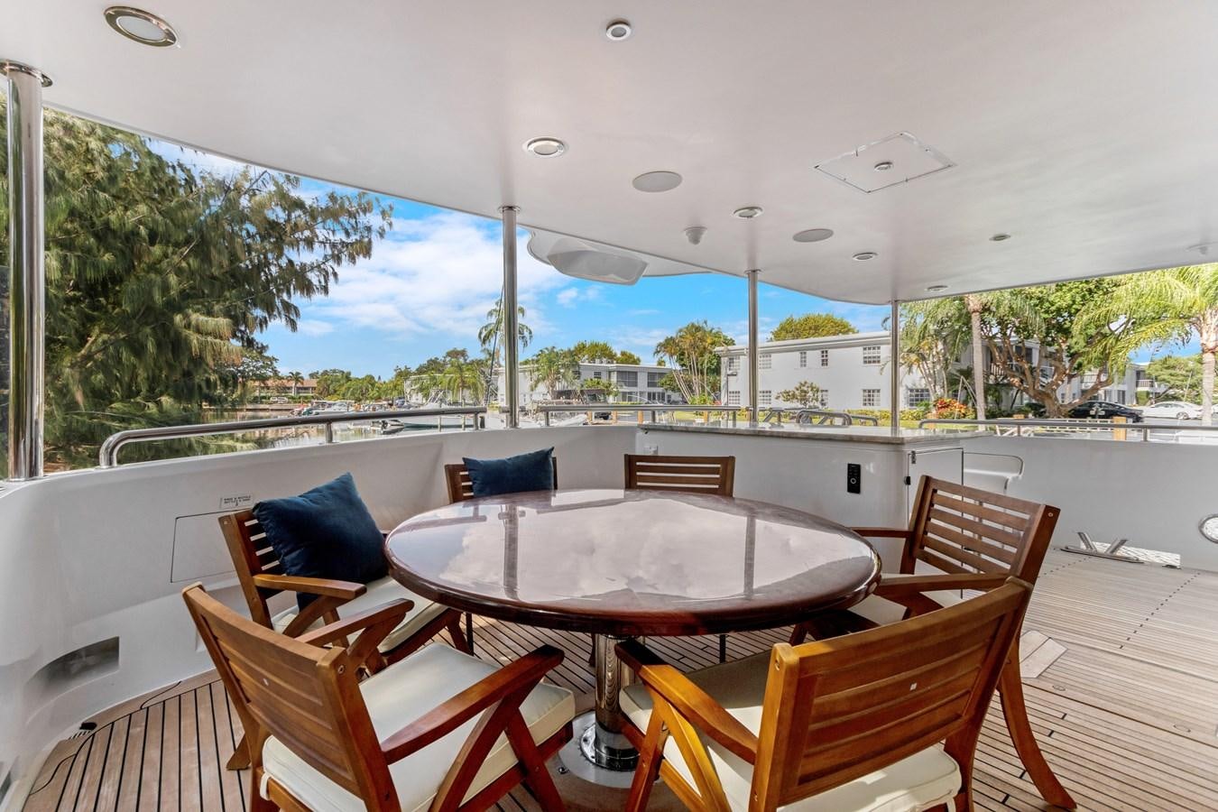 a table and chairs on a deck aboard MAC Yacht for Sale